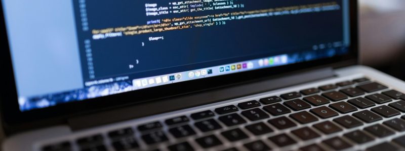 Focused view of programming code displayed on a laptop, ideal for tech and coding themes.